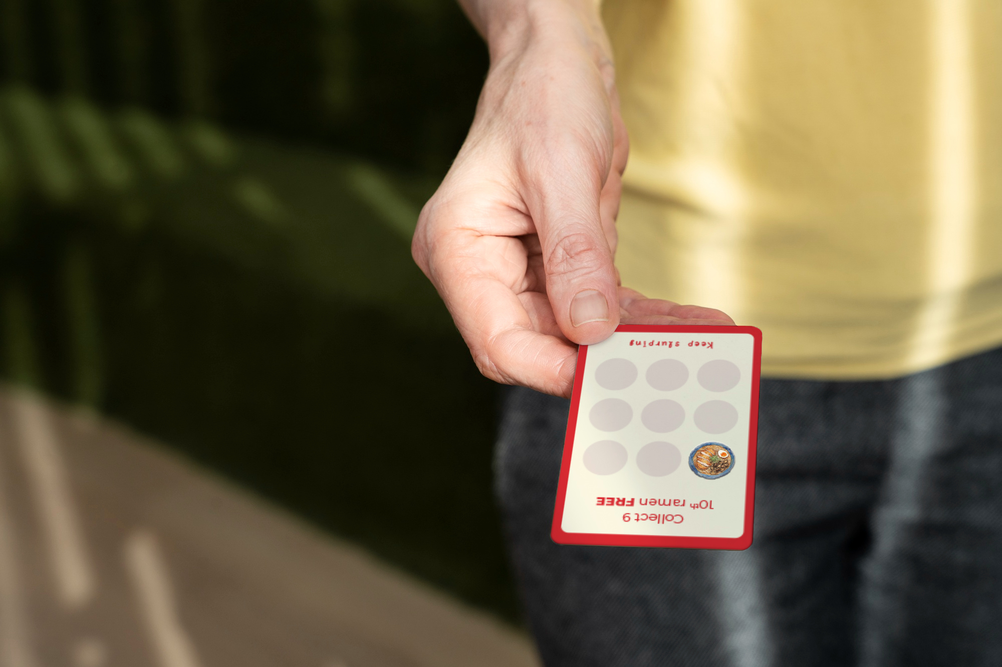 Hand holding the OICHII loyalty card